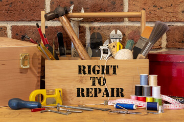 Right to Repair on tool box surrounded by repair tools on bench in cafe used as a repair canter,...