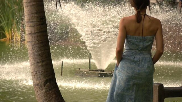 Beautiful woman walking in the city park, slow motion