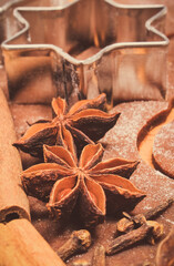 Cookie cutters and spices on dough for gingerbread or other festive cookies. Christmas time