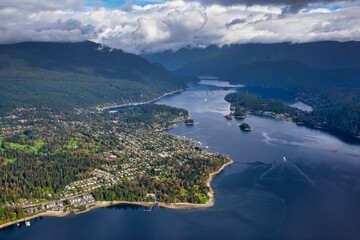 Fototapeta na wymiar Aerial view of an Ocean Inlet in a modern city during a cloudy morning. Taken in Deep Cove, Vancouver, British Columbia, Canada.