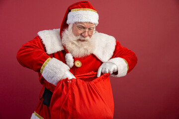 Santa Claus looking inside the gift bag. Christmas is coming. Merry Christmas.