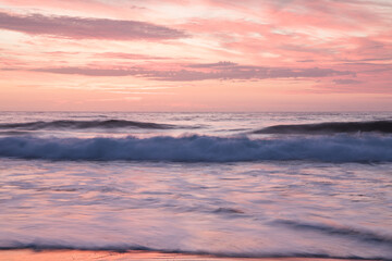 Sunrise over slow motion blurred water 