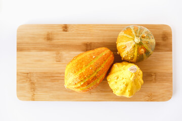 Pumpkin Gourds Fall Decor on Cutting Board and White Background