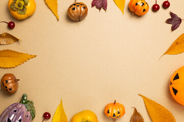Halloween concept. Pumpkin and autumn leaves, sweet persimmon fruit on brown background. flat lay, top view, copy space