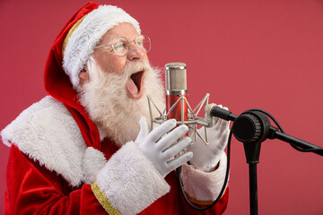 Santa Claus singing or speaking in a studio microphone. Merry Christmas. Broadcaster. Announcer....
