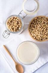 Obraz na płótnie Canvas Soy milk in glass and soy bean on white background 
