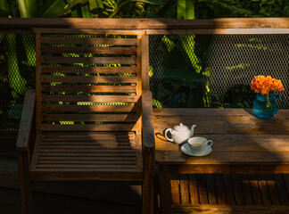 Relaxing corner with beautiful white coffee mugs on a wooden table in a natural setting in the morning.