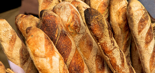 Fresh baguettes for sale in the market.