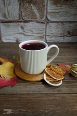 Hot fruit tea with lemon on a wooden background. Selective focus.Still life, food and drink, seasonal  concept.
