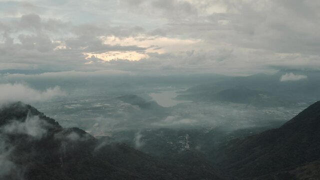 Drone aerial over the clouds, view of lake Amatitlan and mountains in Guatemala.