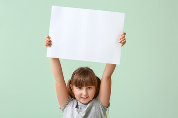 Little girl with blank paper sheet on color background