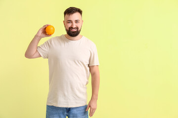 Man with orange on color background