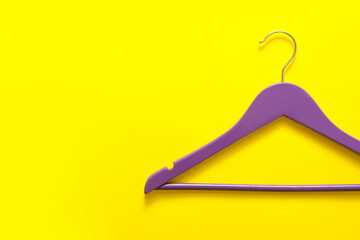 Clothes hanger on color background