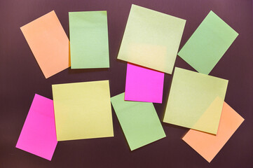 many multicolor sticky stickers on a gray background. yellow, pink and green paper cards mock up with copy space.