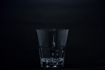 A 100 ml transparent glass on a black background