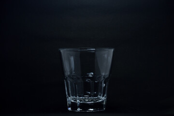 A 100 ml transparent glass on a black background