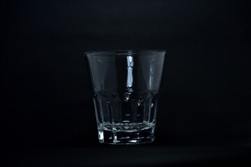 A 100 ml transparent glass on a black background