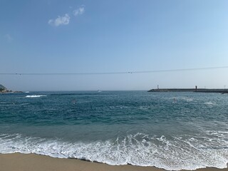 Fototapeta na wymiar Beach, Parasol, Wave and blue sky
