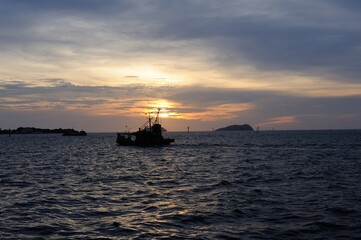 Romantic sunset over the sea with dramatic clouds in the sky perfect for a date