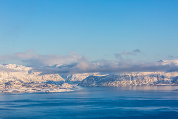 Fototapeta na wymiar Beautiful winter landscape with mountains and fjord
