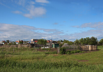 Fototapeta na wymiar village with fences and old rural houses in summer landscape