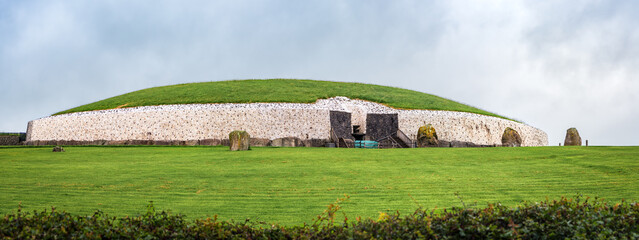 Drogheda, Ireland - July 15, 2020: Panoramic view of Newgrange prehistoric monument which is older...