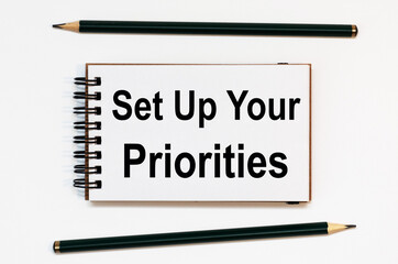 WHITE SPIRAL NOTEBOOK, TWO PENCILS WITH TEXT Set Up Your Priorities