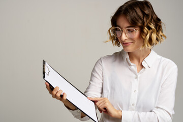 Business woman with folder of documents in hands on gray background cropped view of work