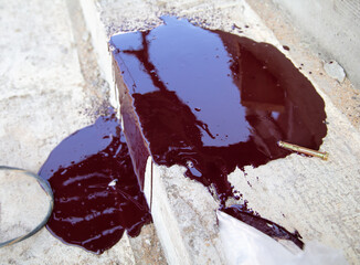 Brown paint spilled on concrete