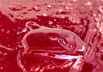 Red oil paint as abstract background.