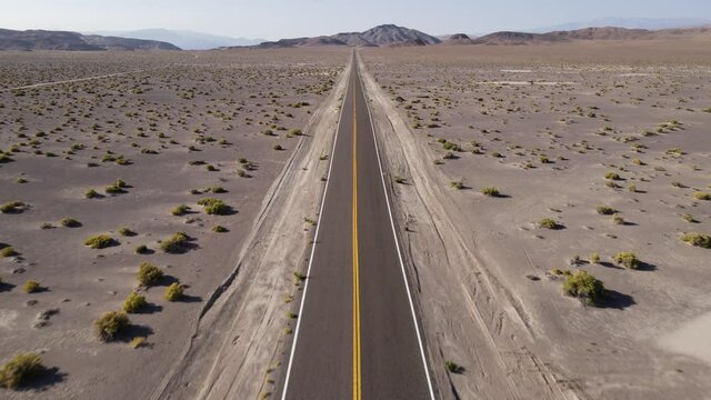 Aerial shot of a remote desert road with no cars in Nevada