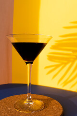 Martini in a glass on summer sunset background.