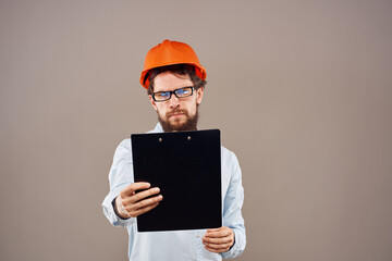Man in orange hard hat professional safety manual documents work
