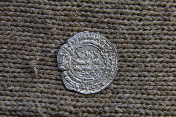 antique arabic silver coin on the table