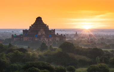 Fototapeta na wymiar Pagoda landscape of Bagan in misty morning under a warm sunrise in the plain of Bagan