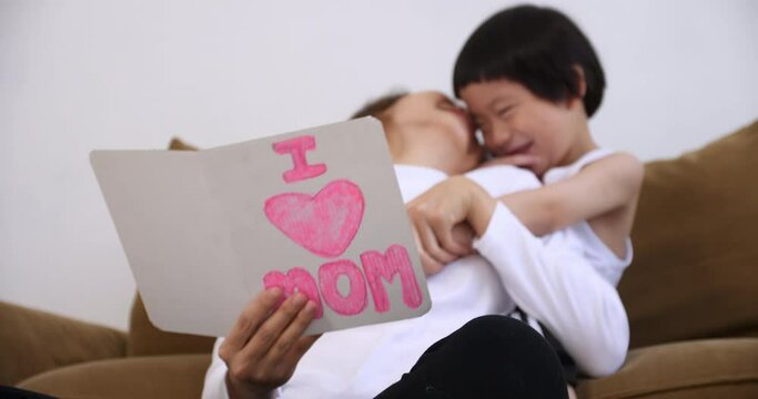 Young mother with her little son spending time together at home.