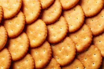 Tasty cracker biscuits on whole background, close up