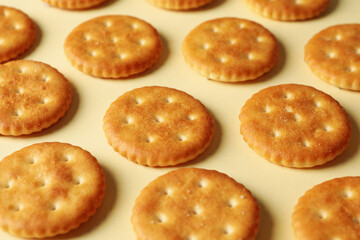 Obraz na płótnie Canvas Tasty cracker biscuits on beige background, close up