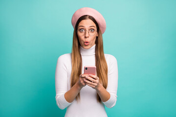 No Photo of attractive shocked lady hold telephone read new post negative comments wear specs modern pink beret cap white turtleneck isolated bright teal color background