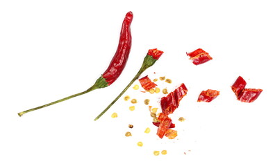 Chopped spicy red peppers, paprika pieces pile isolated on white background, top view