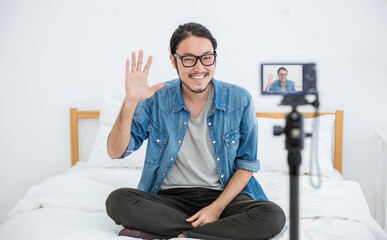 Portrait of small business owner sme vlogger man, video online marketing live in camera. Young...