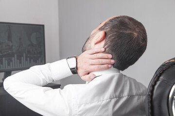 Fototapeta premium Caucasian businessman suffering from neck pain in office.