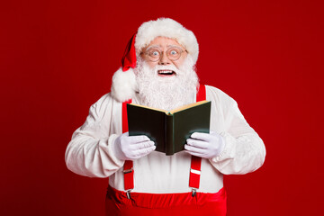 Portrait of his he attractive wise cheerful cheery fat white-haired Santa father reading...