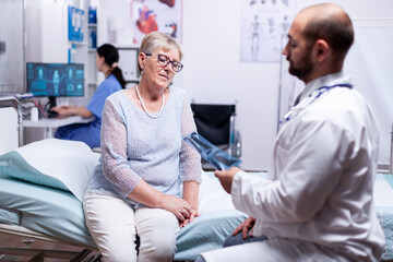 Doctor looking at patient x-ray while discussing diagnosis in hospital examination room. Healthcare medical medicinal system, disease prevention treatment, illness diagnosis