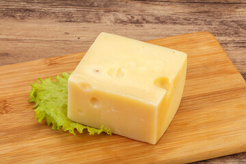 Emmental cheese over wooden board