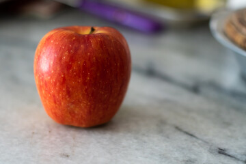 beautiful red apple on marble background natural light