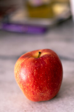 beautiful red apple on marble background natural light