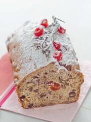 Close up of homemade christmas cake decorated in red and white. Holiday treat. Vertical. Selective focus on the front.
