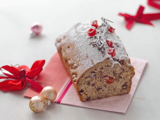 Freshly baked christmas cake decorated in red and white. Holiday treat. Selective focus on the front.
