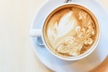 hot cappuccino coffee with nice pattern foam on table